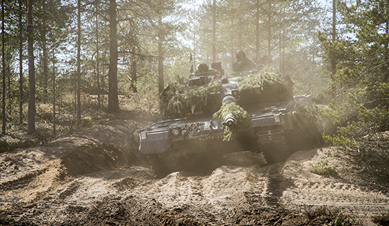 A tank driving in the forest
