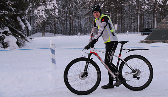 A man riding a bike in winter