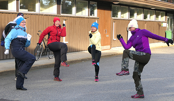 Four women doing excercises outside