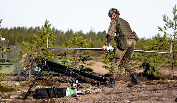 A soldier placinga drone on the launchpad