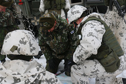 Soldiers on their knees in the snow