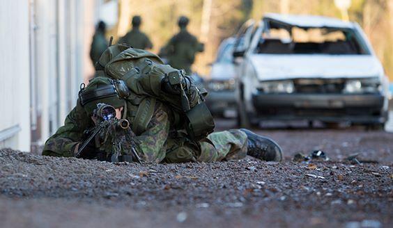 Sniper laying down and aiming in the city