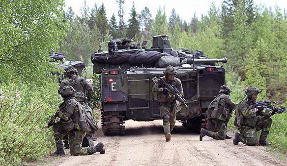 Tank and soldiers by the forest road