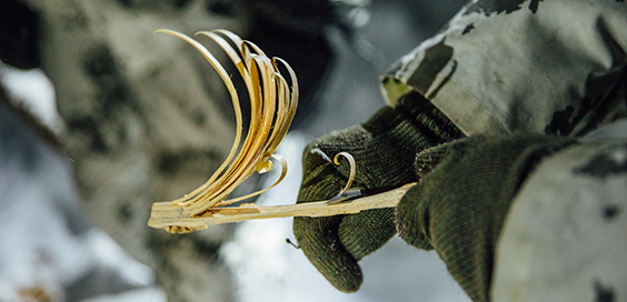 A soldier whips a wooden cane