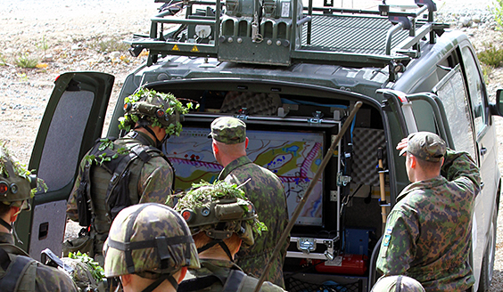 Soldiers look at the display that is on board the van