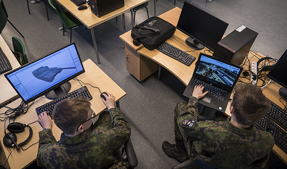 Soldater med datorer. Den andra visar en 3D-modell av en pansarbil på skärmen.