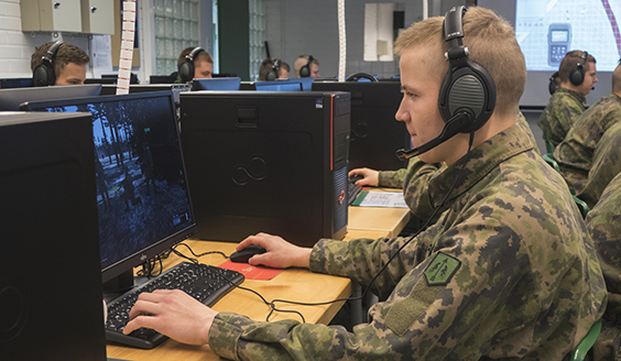 A soldier is playing on a computer