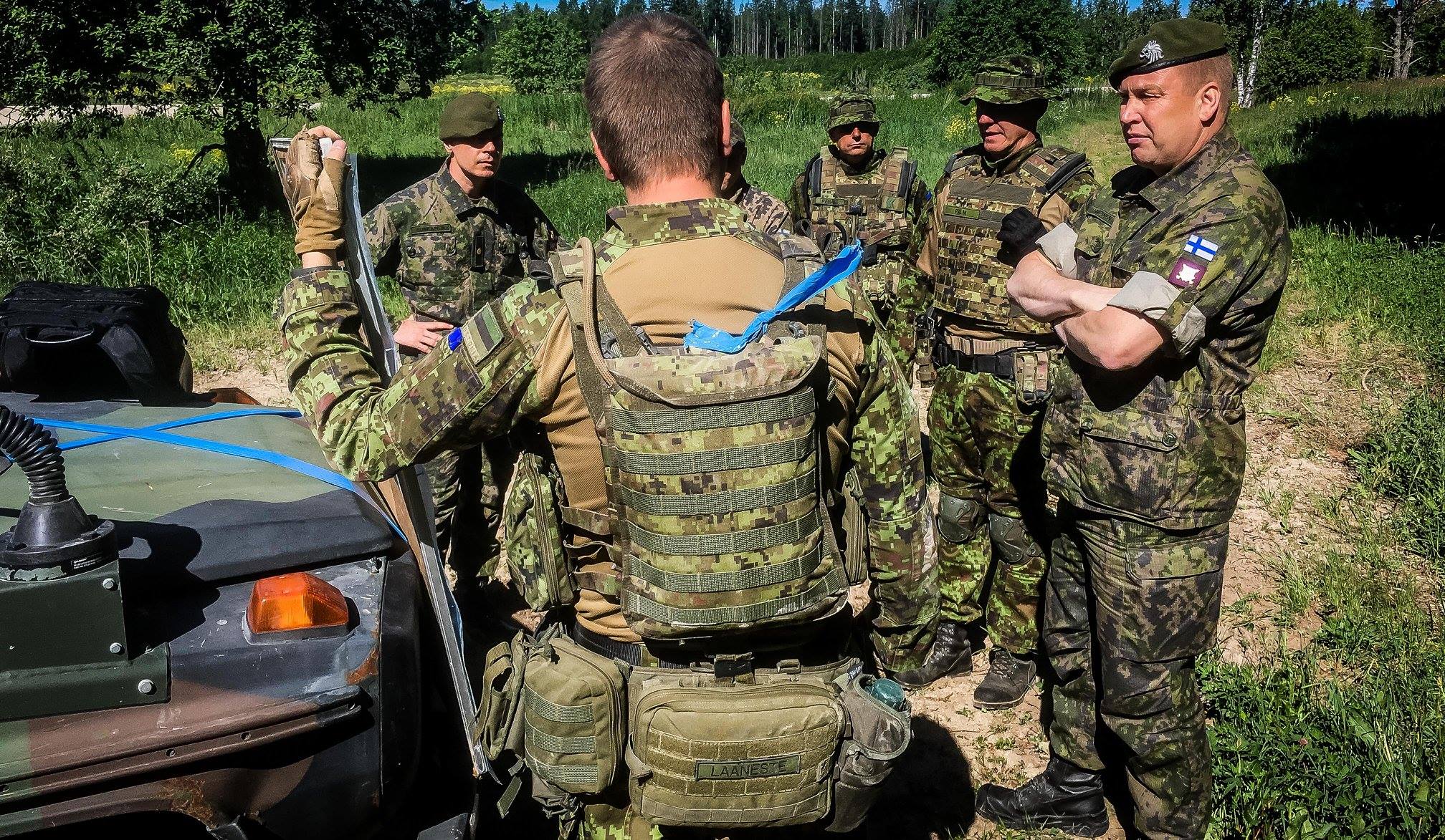 Soldiers talk in the woods