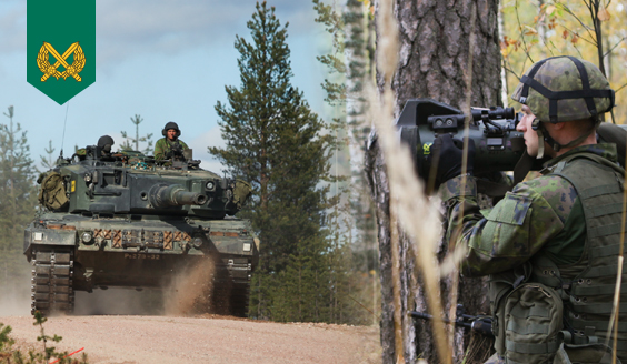 A tank on the road and a soldier with bazooka behind a tree.