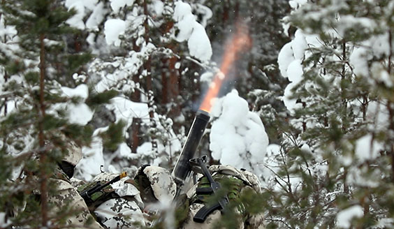 Sotilaat ampuvat kevyellä kranaatinheittimellä. Heittimen piipussa näkyy suuliekki.