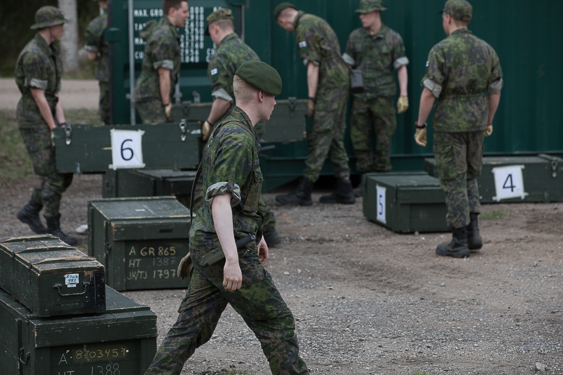 Soldiers carrying numbered crates
