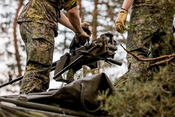 Soldier loading a machine gun