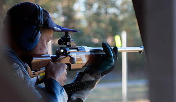 A man aiming with a rifle