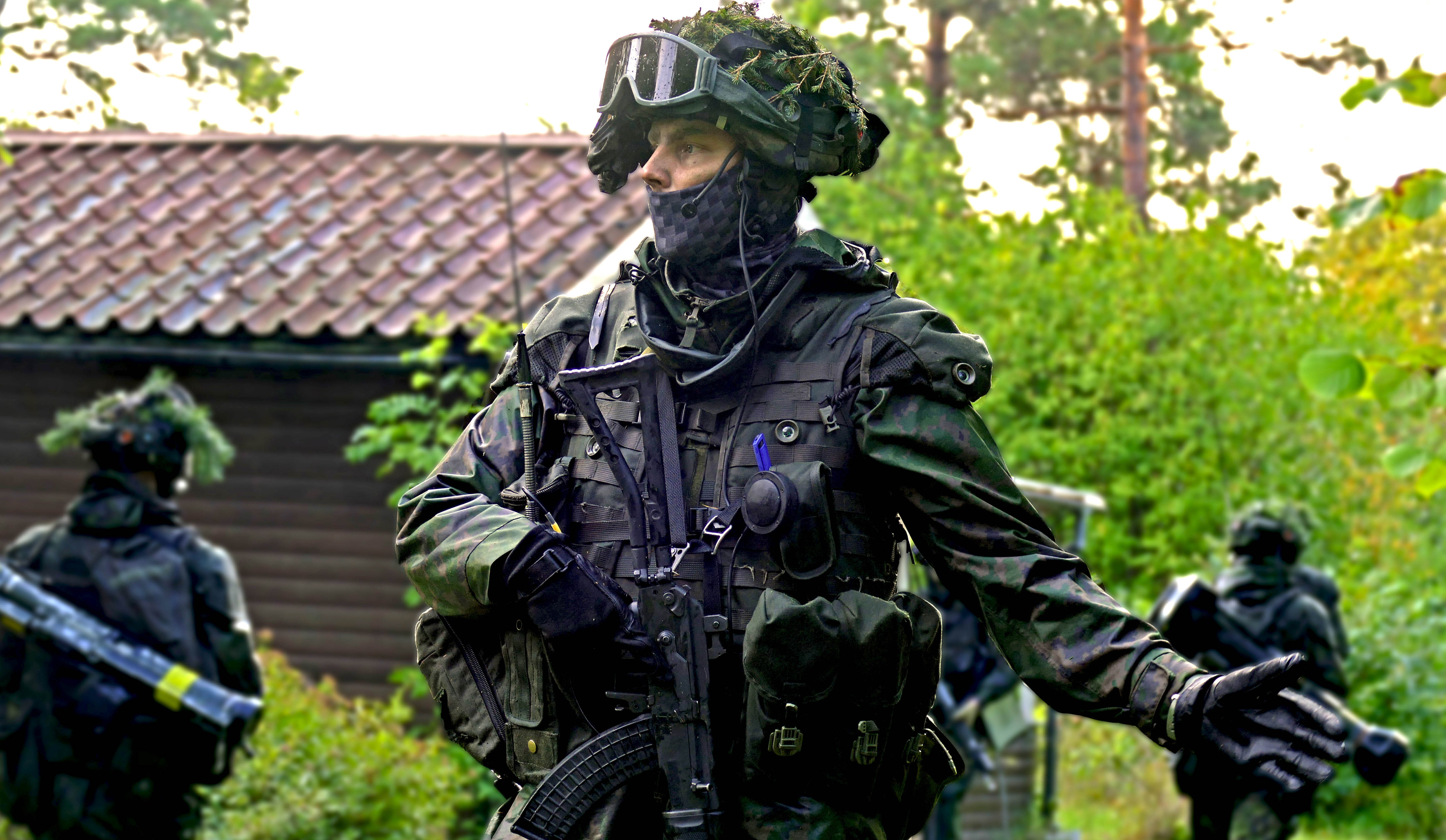 Soldier in combat equipment pointing hand to left