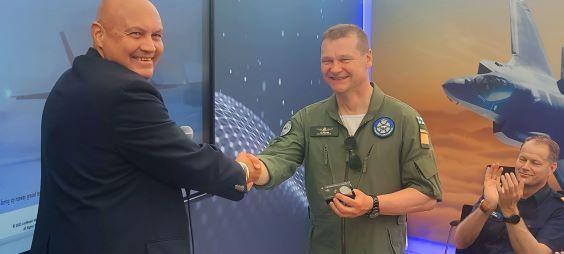 Two smiling men shaking hands