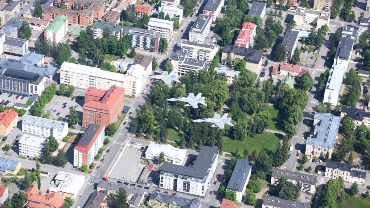 Three Finnish Air Force F/A-18 Hornets flying over the city of Kuopio.