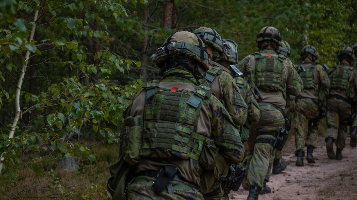 Sotilaita taisteluvarustuksessa juoksemassa metsässä